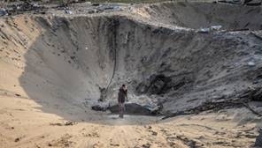 A person standing in a hole in the sand

Description automatically generated