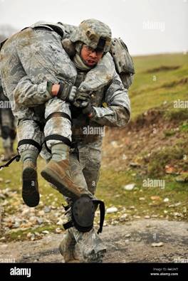 A soldier transports a fellow wounded soldier using the firemanâ€™s carry  technique Stock Photo - Alamy
